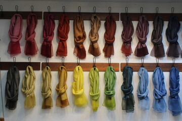 Colorful scarves hung up on the wall