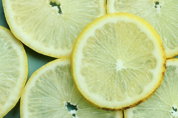 Pile of fresh lemon slices on blue plate