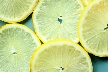 Pile of fresh lemon slices on blue plate