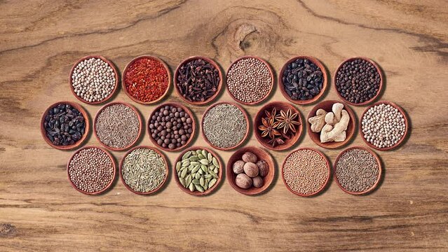 Various set of herb spices in bowl on wood background. healthy life style 4k video