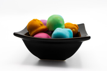 Fondant glazed bonbons filled with a mixture of wallnuts and sugar in a bowl