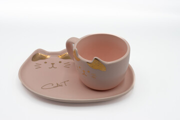 Cute cat teacup or coffee cup on a saucer