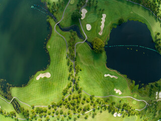 Aerial view of beautiful green golf field fairway and putting green,Top view image for sport...