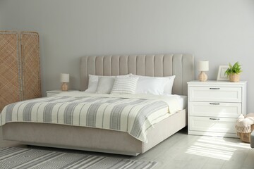 Stylish interior of contemporary bedroom with comfortable bed