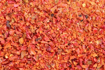 Aromatic spice. Red chili pepper flakes as background, top view