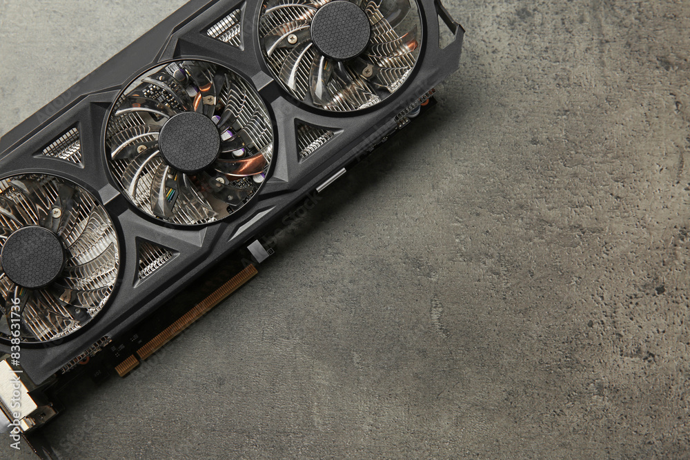 Fototapete one computer graphics card on grey textured table, top view. space for text