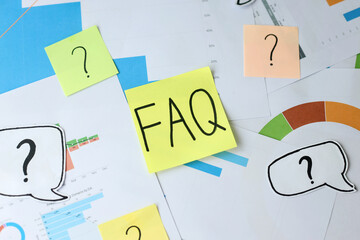 FAQ Written On Yellow Sticky Note With Colorful Question Mark On Documents Background