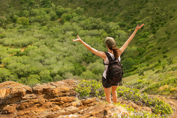 Happy female hiker feeling free in nature 