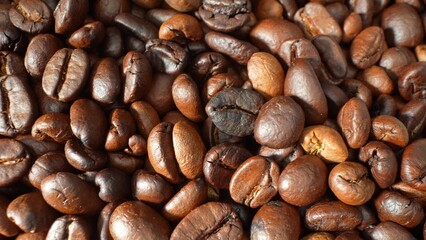 A captivating symphony of roasted coffee beans, each one a masterpiece of the roaster's craft. Their lustrous, deep brown hues beckon, promising a sensory journey through rich, aromatic depths.
