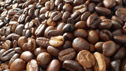 The world of coffee with this captivating close-up, revealing the intricate spectrum of dark brown tones and lustrous finishes on roasted beans, each telling a story of unique roasting techniques.
