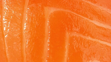 Behold the mastery of slicing as this image unveils the lush orange tones and intricate marbling of premium salmon. Each precise cut whispers of freshness and culinary expertise.
