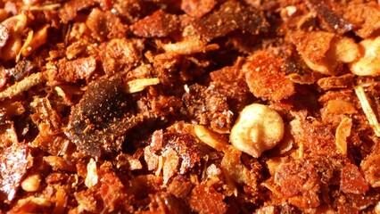 Zooming in on fiery ground chili, its vibrant red and earthy brown hues form a tapestry of spice. Flecks of seeds and flakes promise a flavor explosion, embodying the essence of heat.

