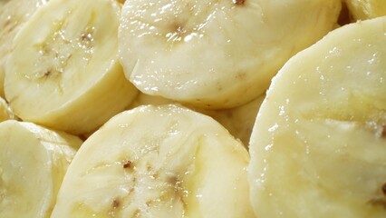 A close-up snapshot captures the allure of ripe banana slices, their glossy surface hinting at their juiciness. Arranged in a tempting heap, they beckon with promises of tropical sweetness.
