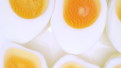 Sliced boiled eggs unveil a tantalizing sight: velvety, golden yolks ensconced in a pristine halo of firm whites. Their glossy sheen beckons, promising a culinary symphony of smoothness and delicacy.
