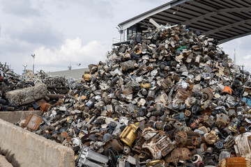 Recycling yard. Industrial scrap metal recycling. Metal car parts in junk yard