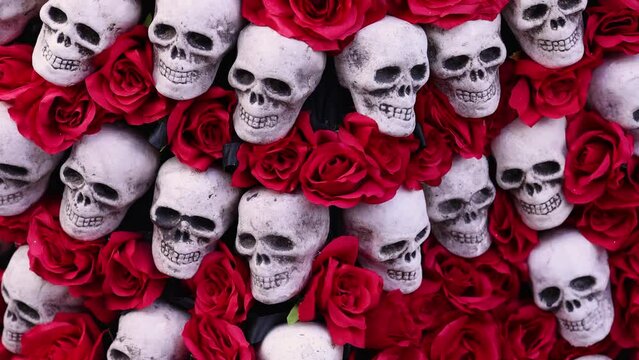 Background of red roses and skulls, for Dia de Los Muertos celebrations