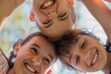 Close up face of happy children embracing each other and smiling, group of joyful kids playing...