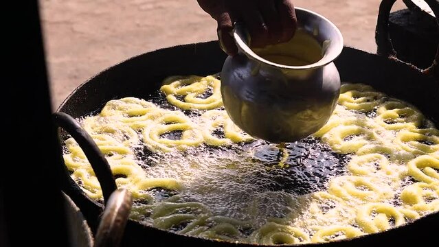 Jalebi or jilipi, a spiral shaped sweet dish cooked in hot oil for hindu festival of ratha Yatra. It is a traditional indian dessert made from deep frying flour batter and dipping in sugar syrup.	