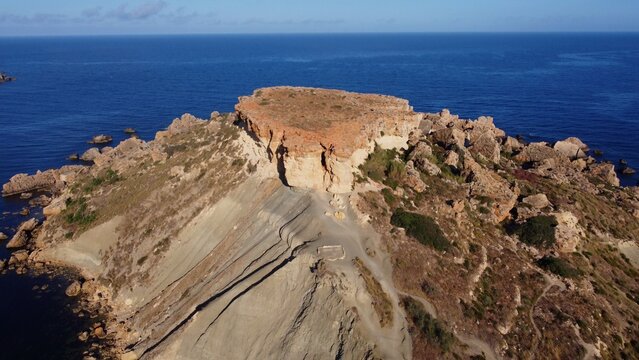 Qarraba Bay flat rock cape Malta, Aerial establishing shot in the morning sunlight. High quality photo