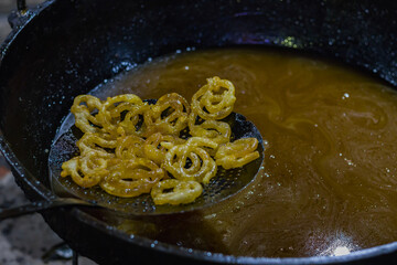 Jalebi or jilipi, a spiral shaped sweet dish being cooked for hindu festival of ratha Yatra. It is...