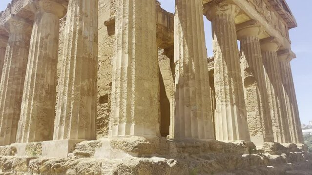 Close shot of the columns of an ancient Greek building Valle dei Templi skyline