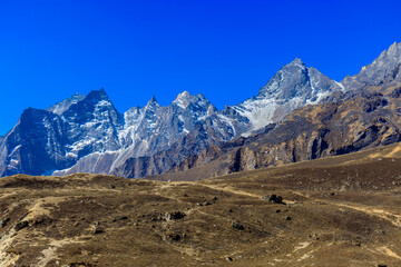 Himalaya mountains landscape with high altitude snow and ice glacier summit peaks. Everest Base Camp Solo Khumbu trekking region in Nepal. Beautiful Himalayas eight thouthander summits under blue sky