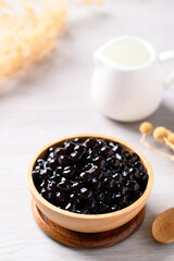 Black tapioca pearls or boba in wooden bowl, Ingredient in bubble tea