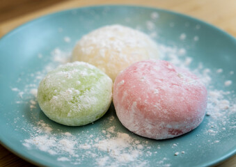 Different color delicious Japanese mochi on the blue plate