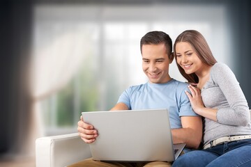 Happy man and woman relax with computer at home