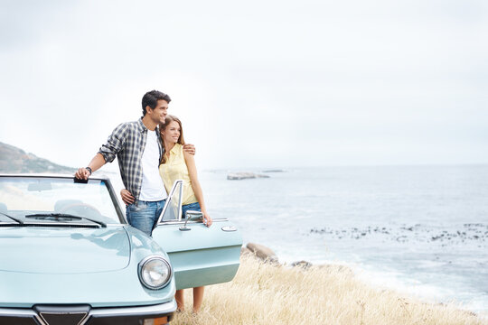Beach, view and happy couple hug on road trip in nature together for peace, travel or adventure. Thinking, convertible and people in car on vacation for journey, love and honeymoon romance in Italy
