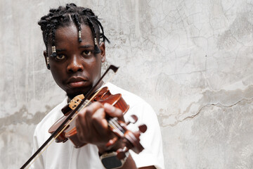 African American young man playing on violin.