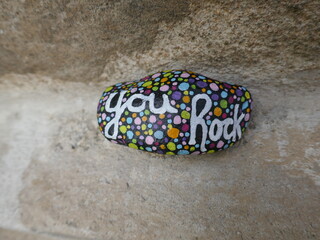 Stone surface with motivational kindness rock