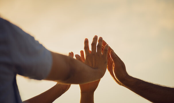 Close up people putting their hands together. Friends hands showing unity and teamwork, friendship, happiness and partnership team concept.