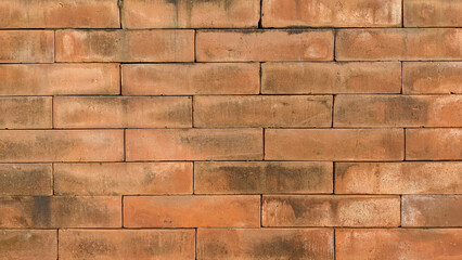 Weathered red brick wall texture, close-up shot. Red brick surface with rustic charm
