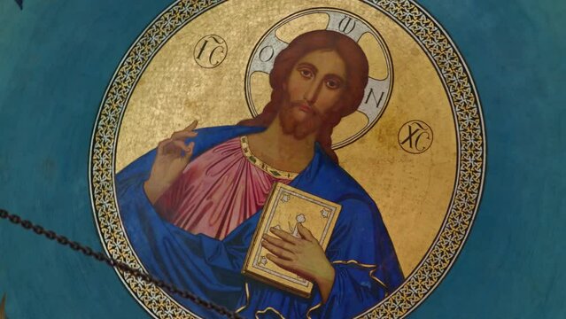 Golden ceiling mosaic of Jesus Christ blessing and holding Holy Bible.
