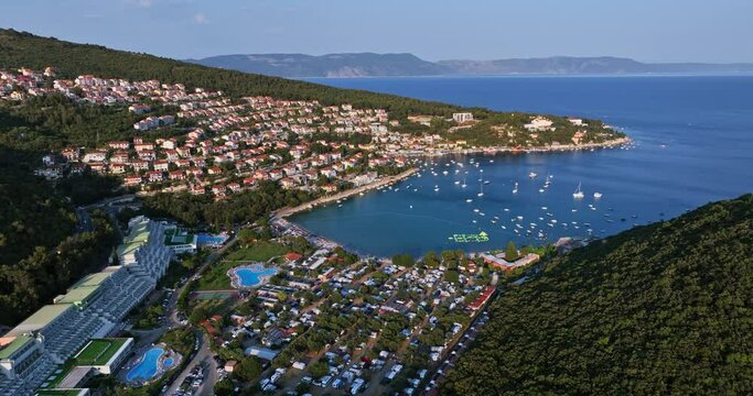 Aerial flying around the Rabac town and resort, sunny evening in Istria, Croatia