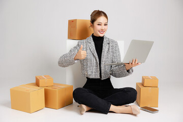 Portrait Asian smart entrepreneur business woman in casual suit surround by parcel boxes service...