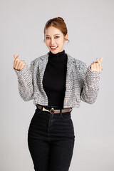 Asian smart happy entrepreneur business woman smile in casual suit gesture showing love sign and...