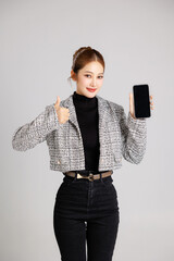 Asian smart happy entrepreneur business woman smile in casual suit gesture showing blank screen...