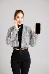 Asian smart happy entrepreneur business woman smile in casual suit gesture showing blank screen...