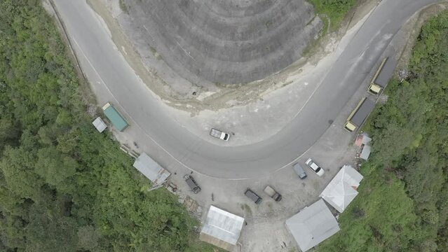 Establish aerial view of Extreme road surrounded by green and beautiful mountains in Malalak subdistrict, Agam district. West Sumatra. d-log raw stock video