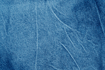 Texture of a blue stone-washed denim fabric