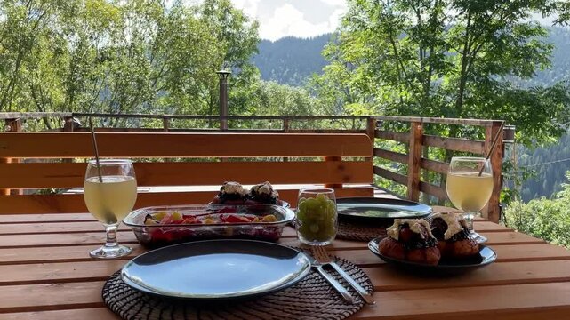 Romanian traditional fish dish with papanas and drinks