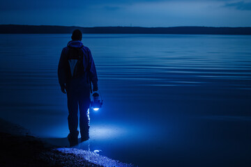 AI Generated Photo of a Solitary Lantern: Man with Lantern by the Lake at Night