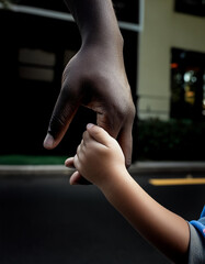 Close-up of a fathers hand holding onto his childs hand for fathers day.