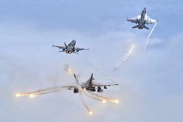 Jet fighters firing chaff flare during training