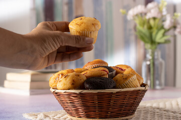 muffins on a table with books and flowers