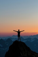 Silhouette of a person standing triumphantly with arms outstretched on a rugged mountain peak.