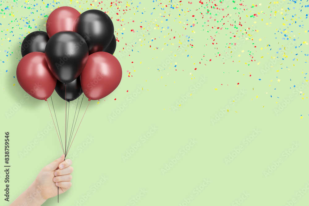 Poster female hand holds bunch of red and black balloons on mint background with confetti. empty space for 