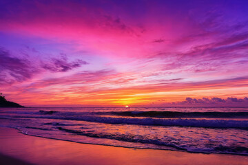 Obraz premium A serene sunset beach silhouetted against a sky painted in hues of orange, pink and purple